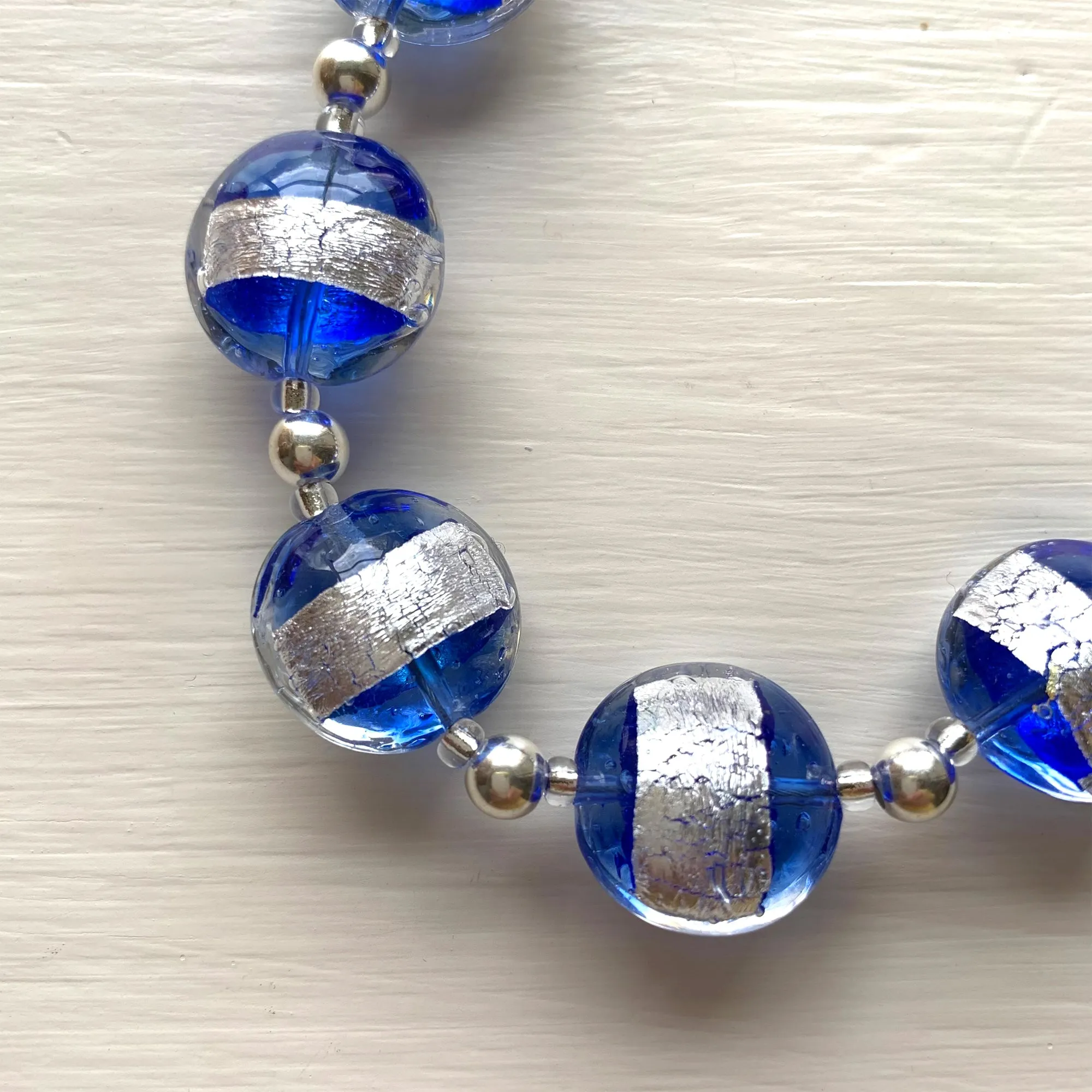 Necklace with blue translucent and silver Murano glass medium lentil beads on silver